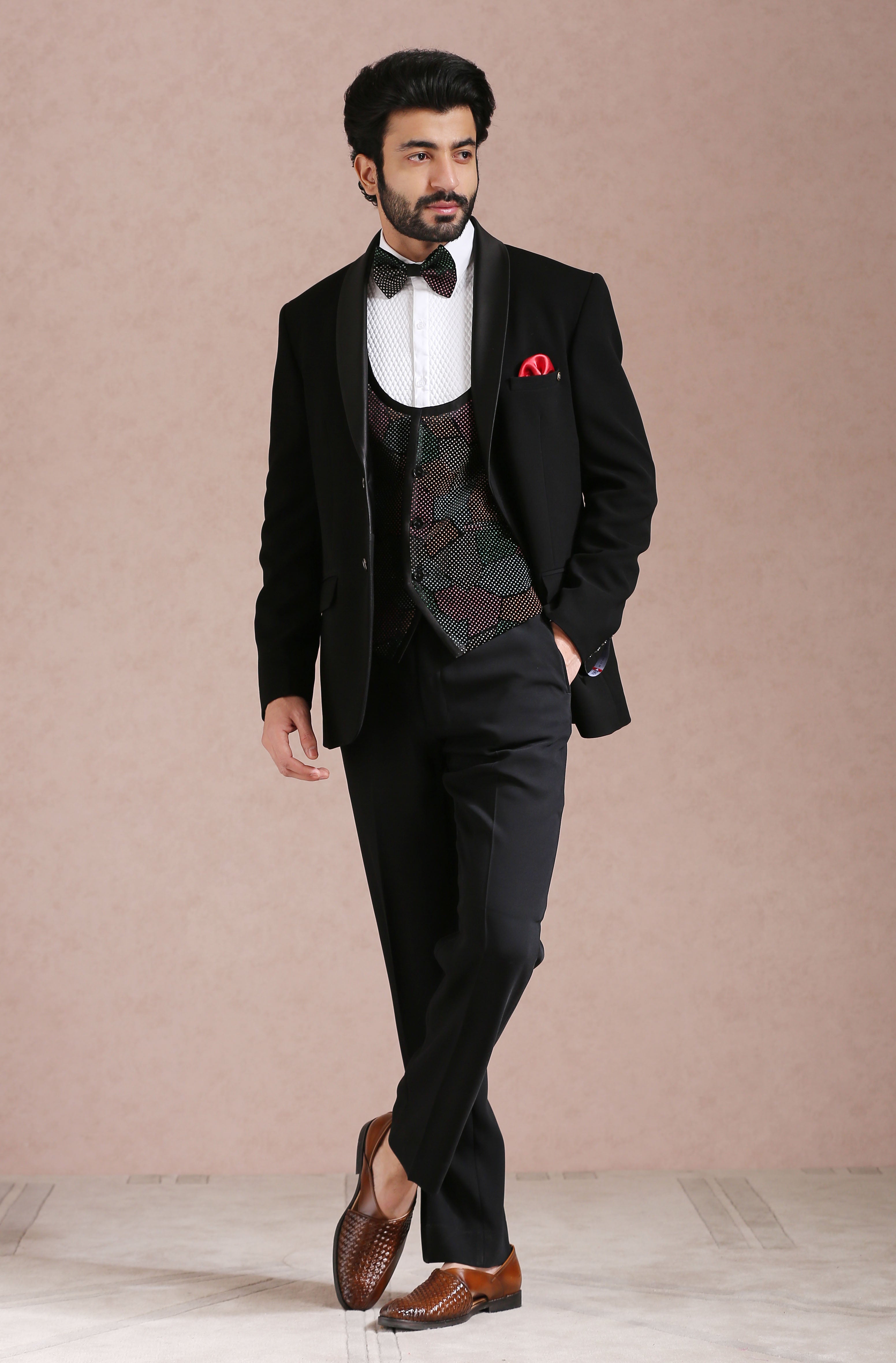 A stylish black tuxedo suit, the epitome of elegance.
