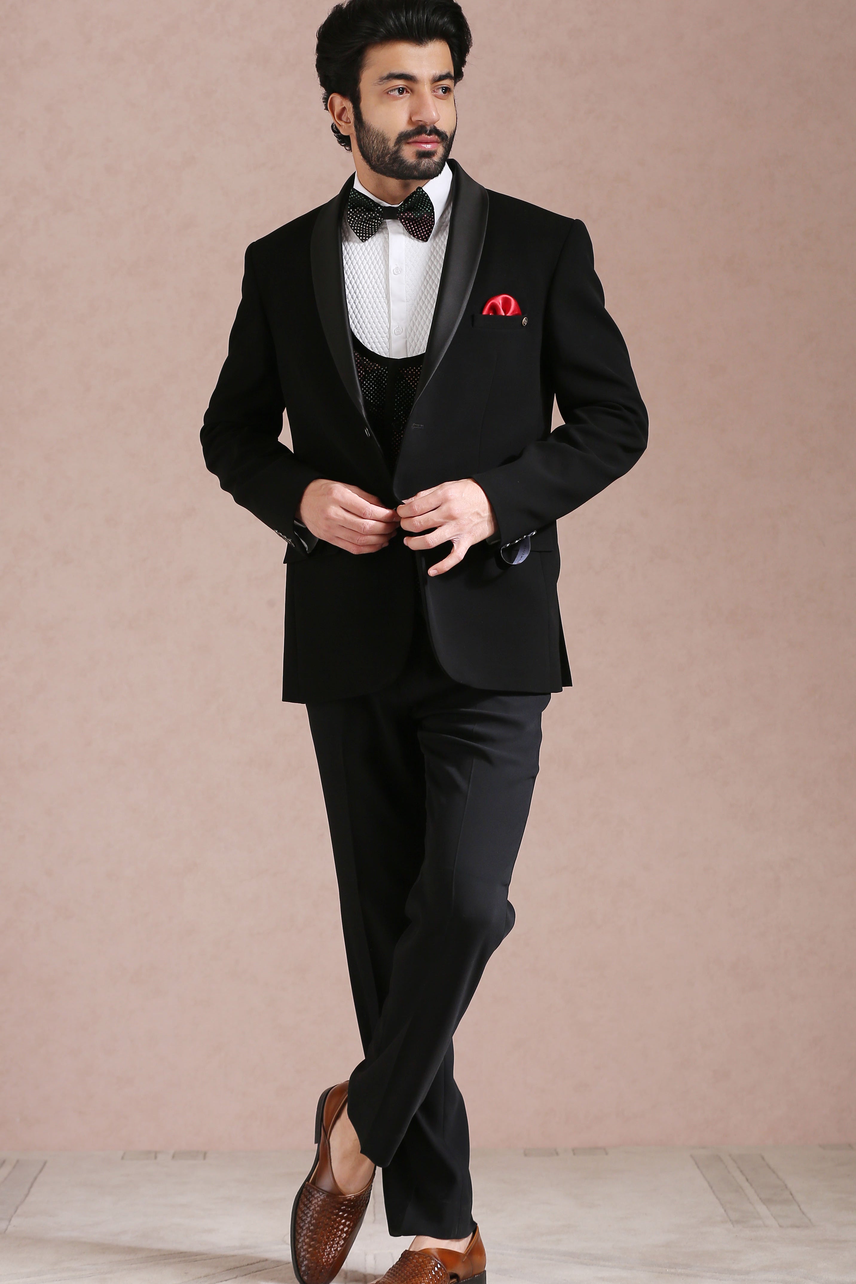 A classic black tuxedo suit, perfect for formal occasions.
