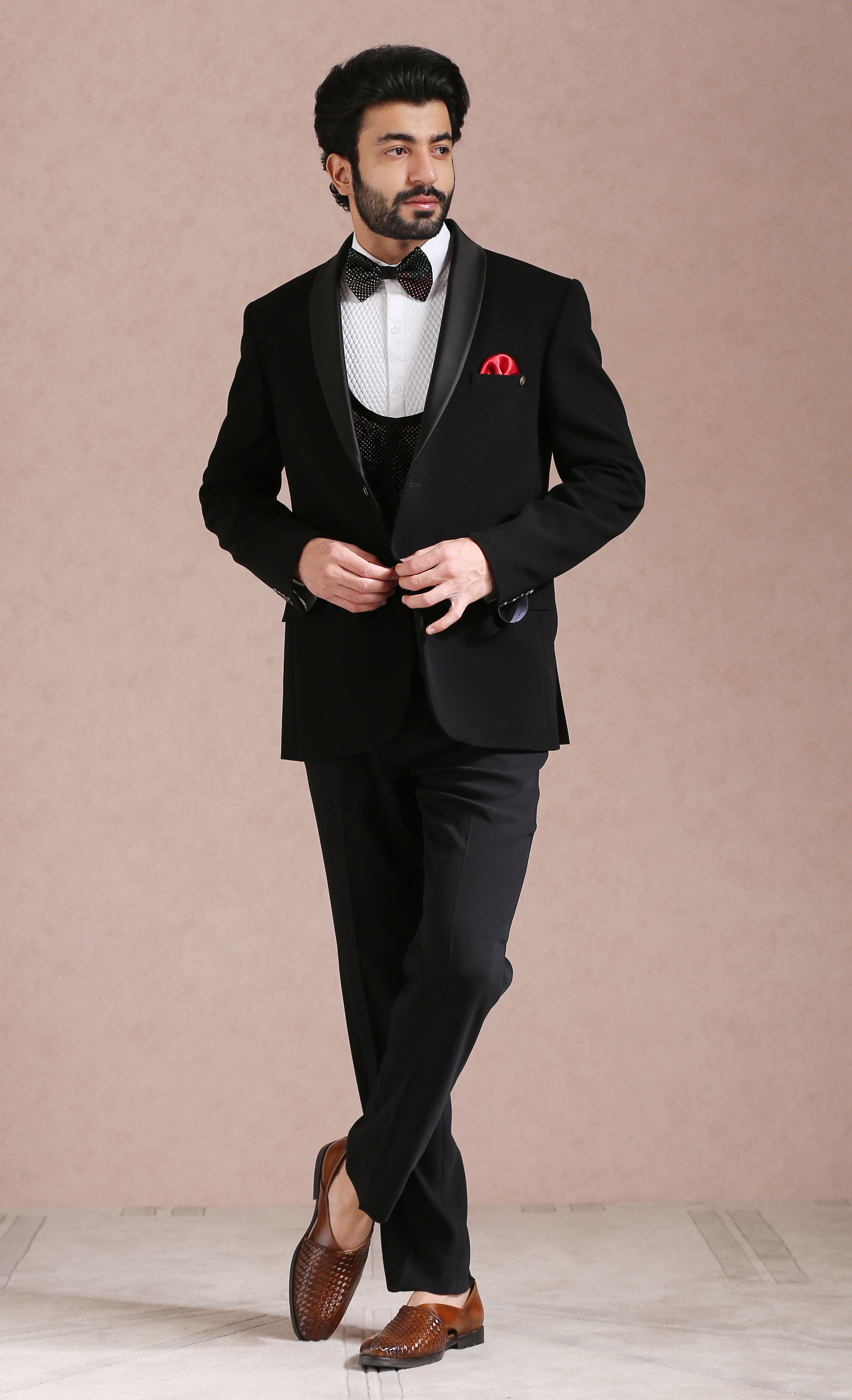 A classic black tuxedo suit, perfect for formal occasions.
