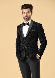 A stylish black velvet suit, the epitome of elegance.
