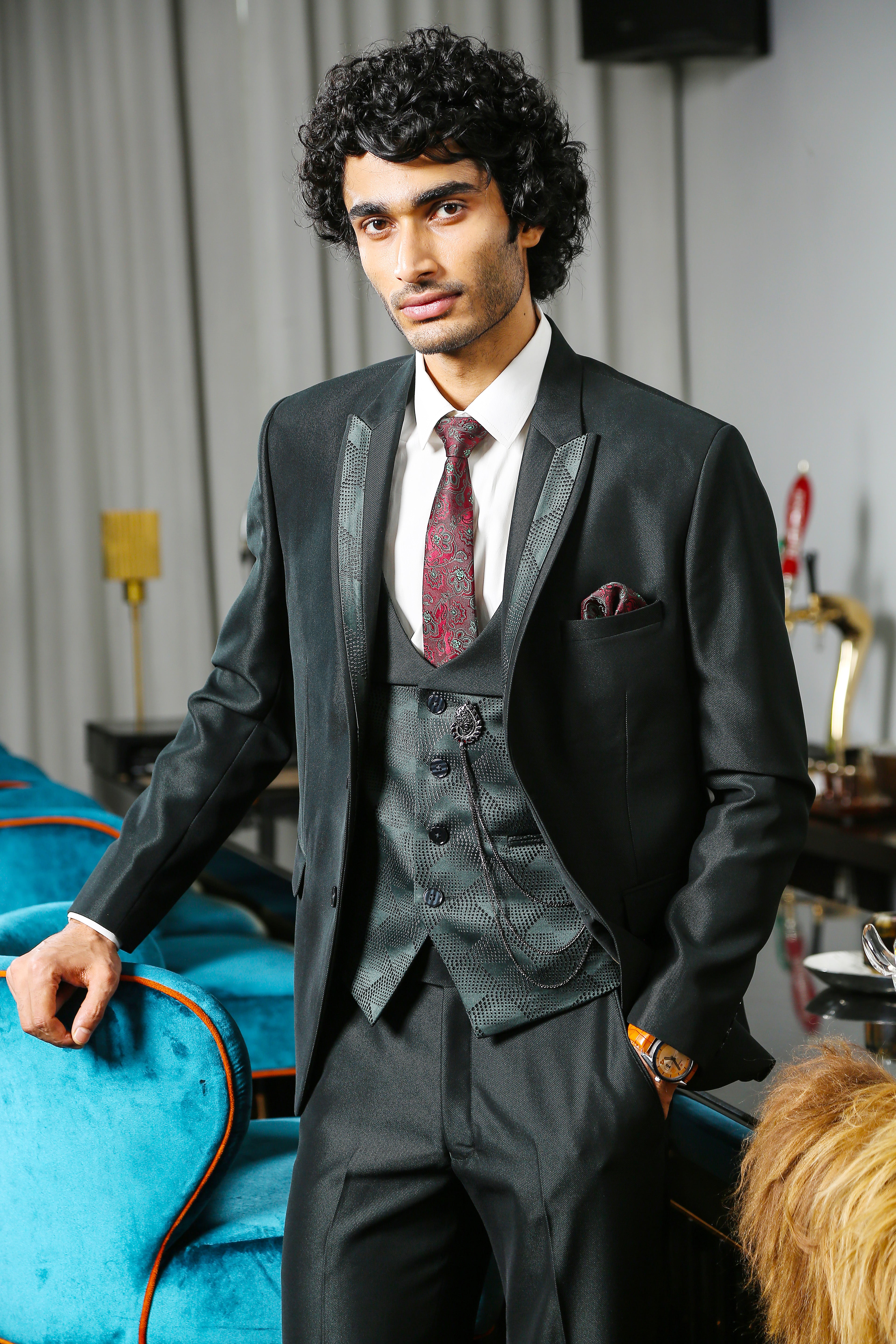 A luxurious green suit with designer vest, perfect for special occasions.
