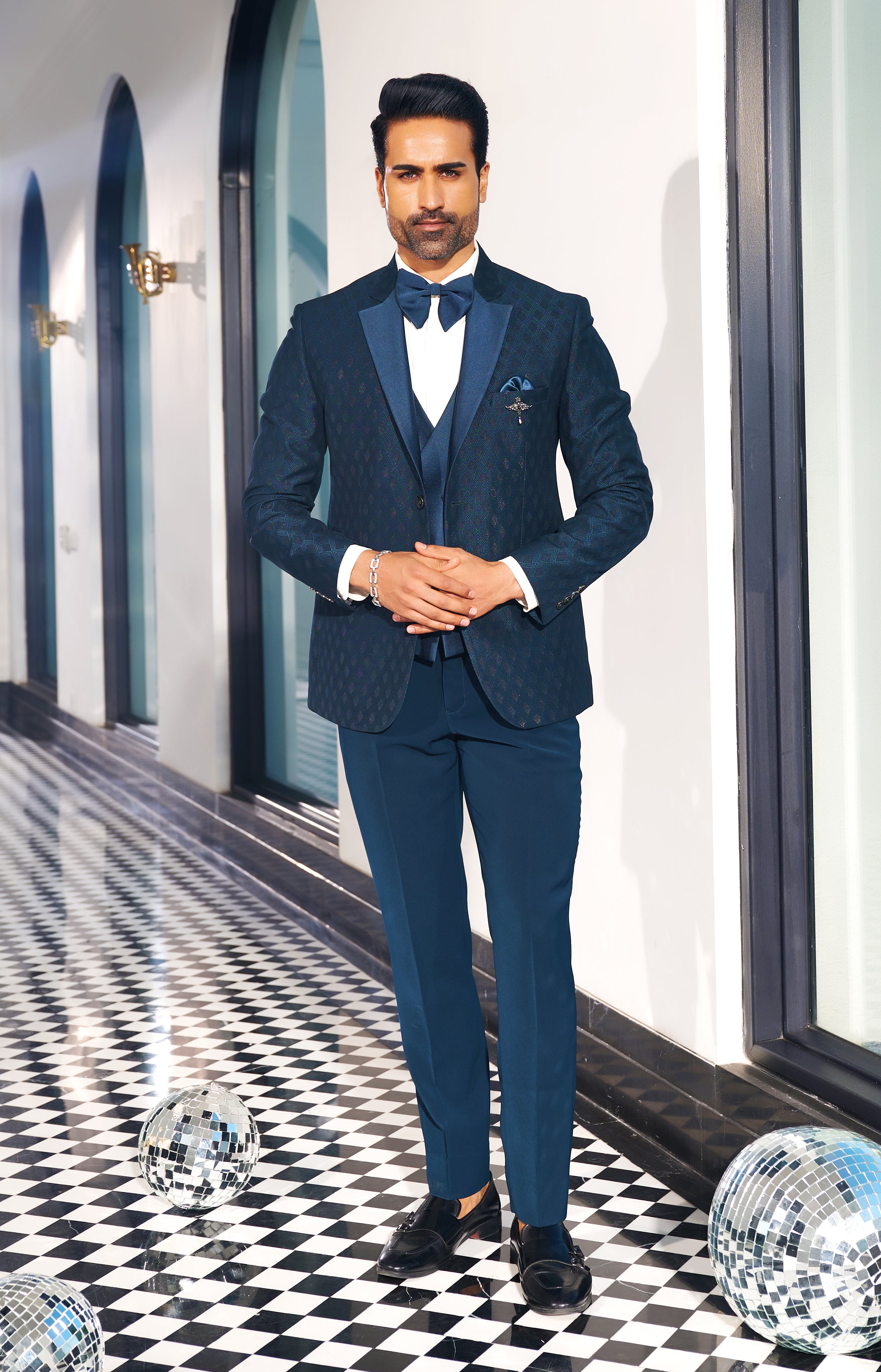 A luxurious teal suit with designer vest, perfect for special occasions.
