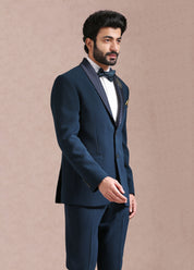 A timeless teal suit with embroidered motif.


