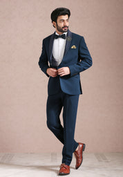 A versatile teal suit with embroidered motif, suitable for various occasions.
